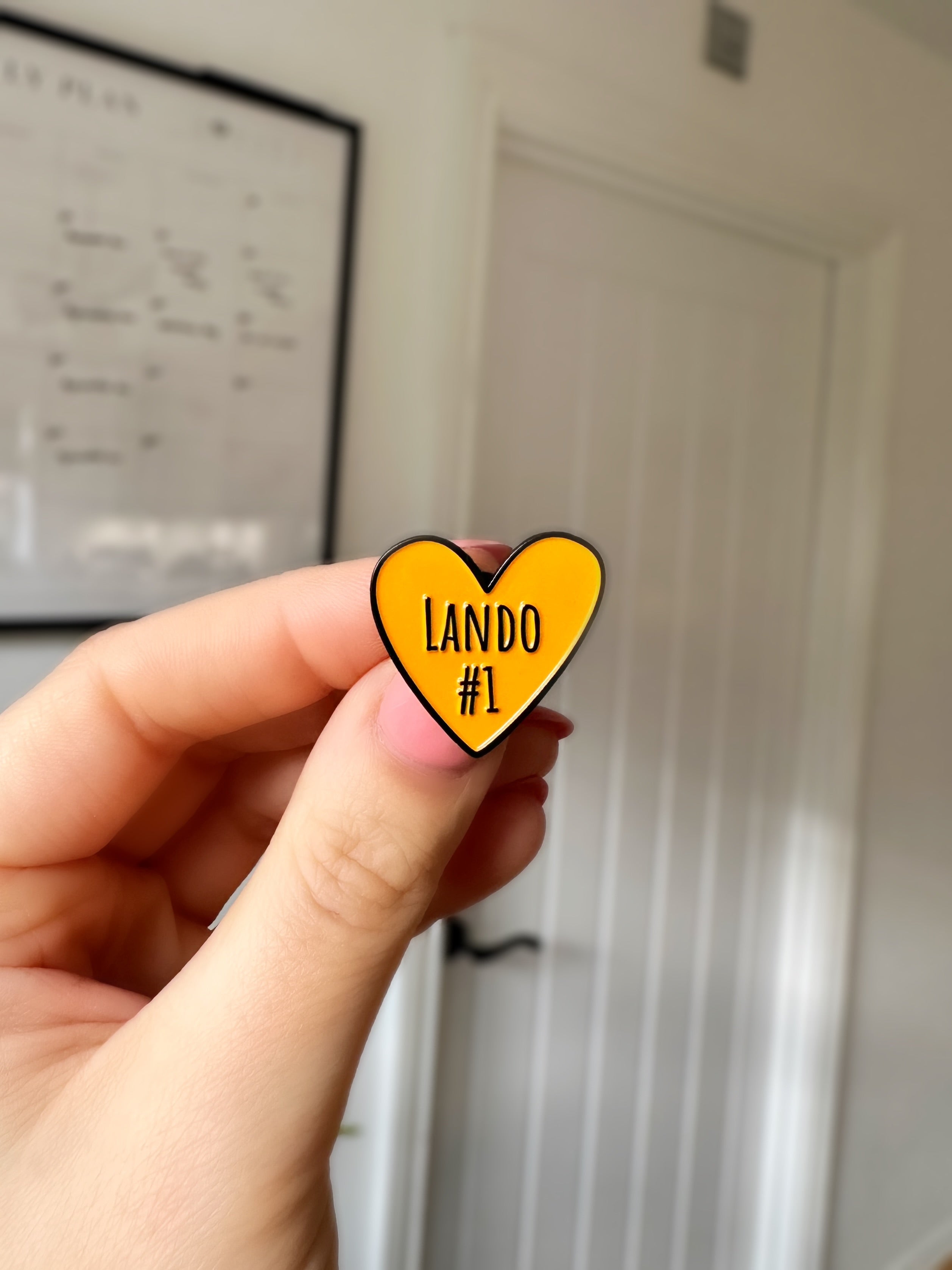 Lando Norris F1 love heart soft enamel pin badge — angled view