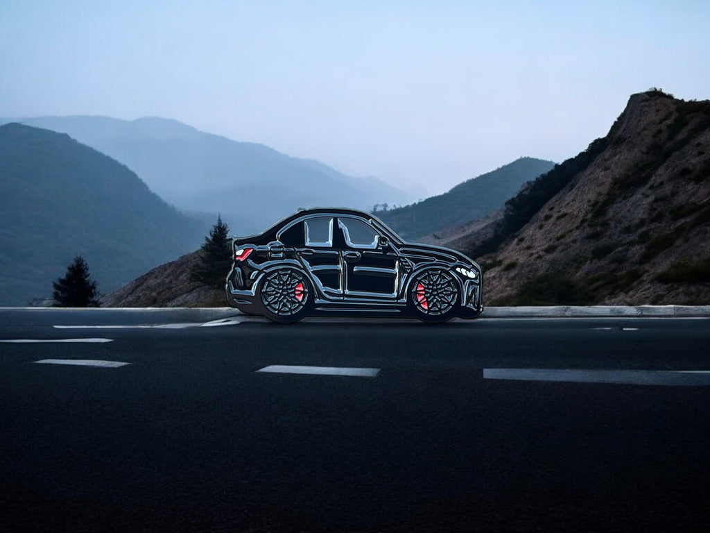 Sapphire Black BMW M3 G80 pin badge — angled view