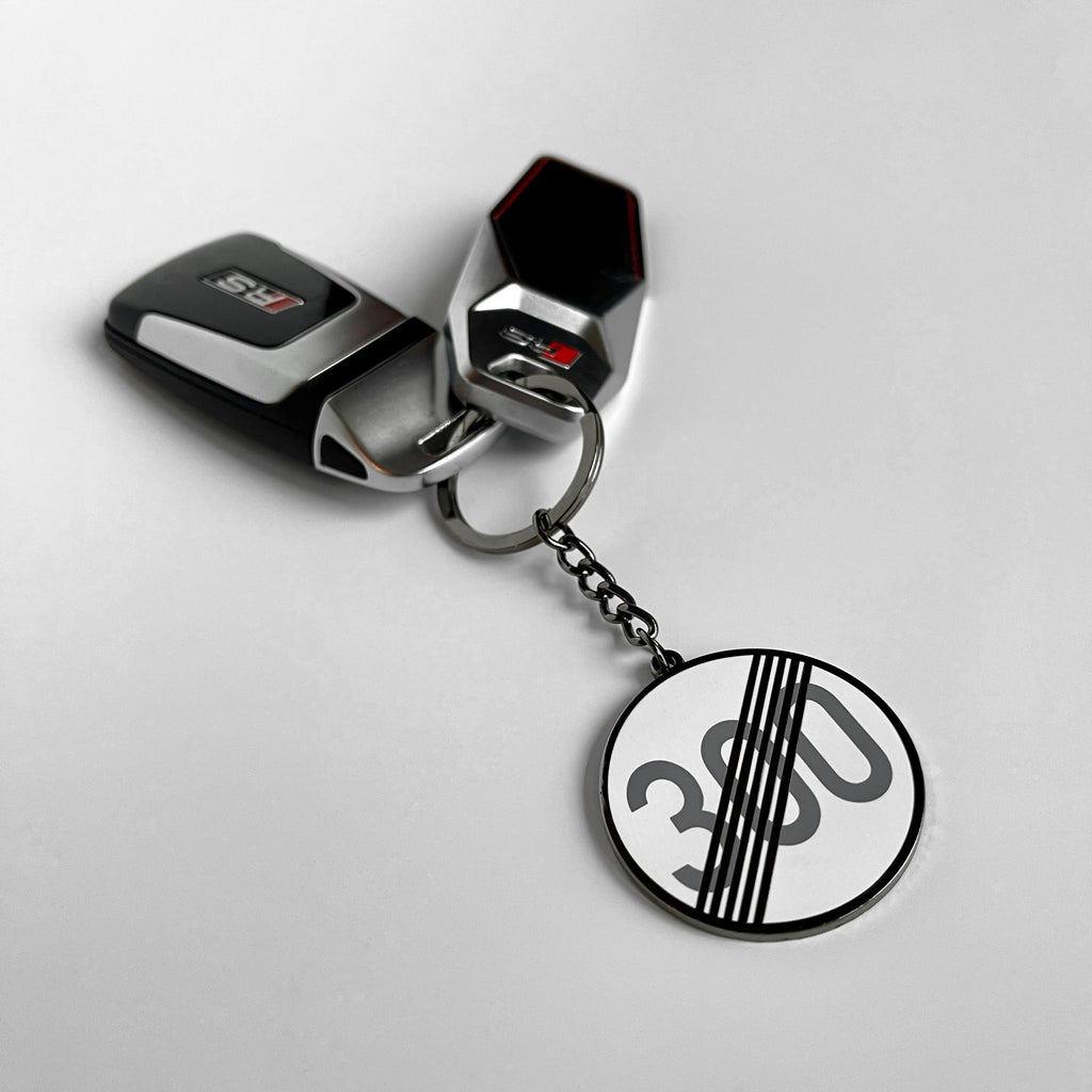 Autobahn derestricted sign hard enamel keyring — angled view