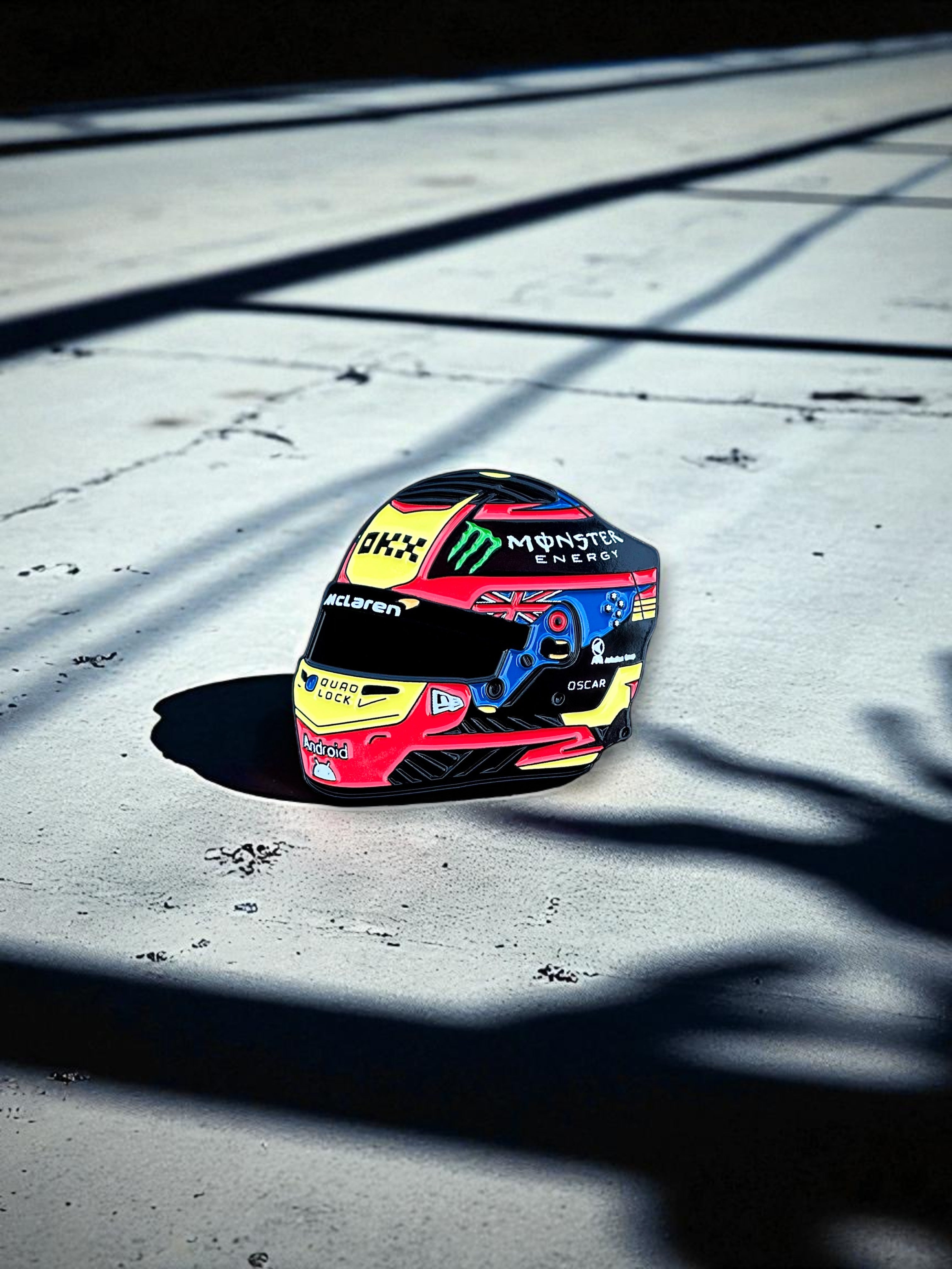 Oscar Piastri F1 helmet soft enamel pin badge — angled view